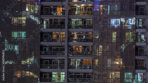 Night view of exterior apartment building timelapse. High rise skyscraper wit...