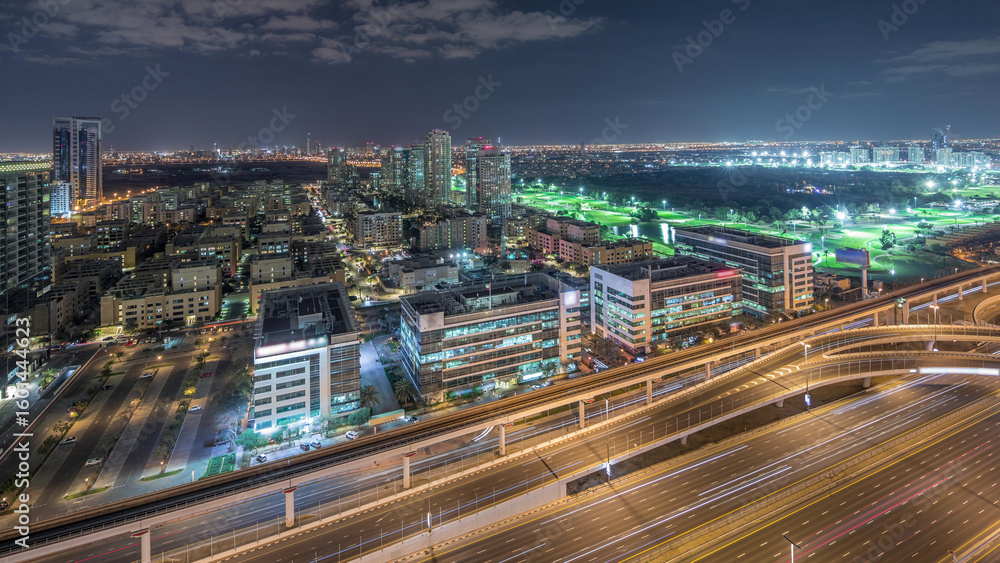 Fototapeta premium Tecom, Barsha and Greens districts aerial view from Internet city night timelapse