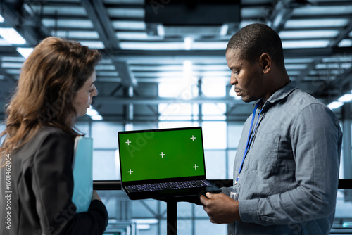 Tableau sur toile Engineer in data center using green screen laptop, refining server virtualizatio