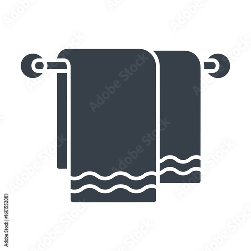 Two dark towels hanging on a rod, featuring a wavy design on the bottom edge.