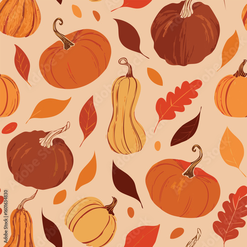 Seamless pattern of orange pumpkins and autumn leaves
