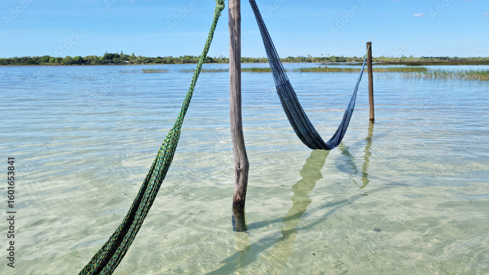 Fototapeta premium Hammock Over the Crystal Clear Waters of paradise lagoon, Jericoacoara, Brazil