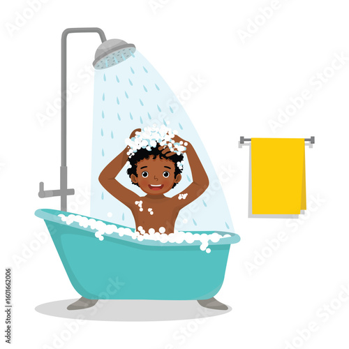 Little African boy taking a shower in the bathtub
