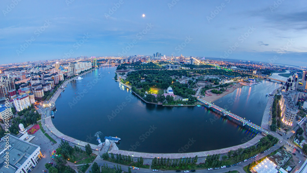 Obraz premium Elevated view over the city center with river and park and central business district day to night Timelapse, Kazakhstan, Astana