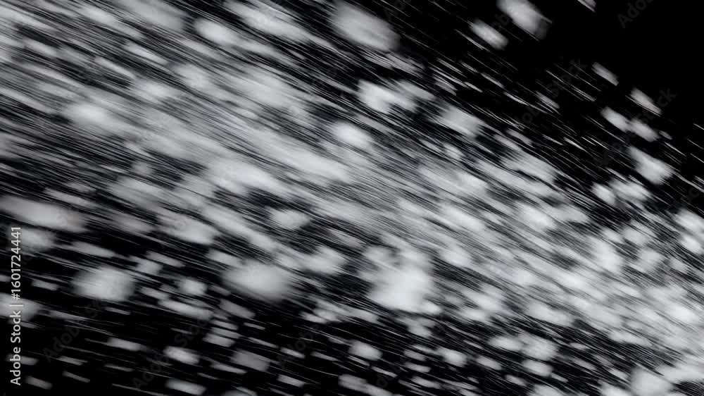 seamless video 4k winter animation heavy snowflakes blown sideways wind against black backdrop creating fast paced snowstorm effect perfect holiday visuals action
