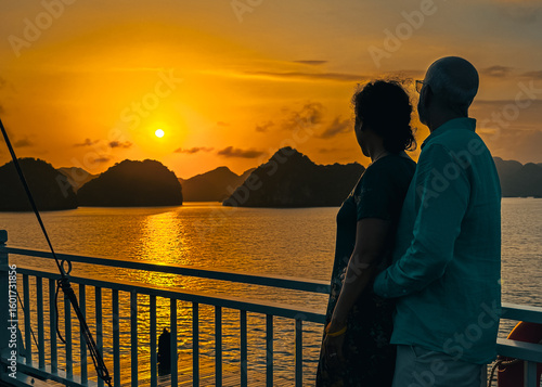 Photos Couple watching the sunset from their cruise ship