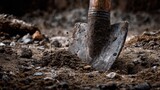 Close-up of a dirty shovel in the ground during excavation