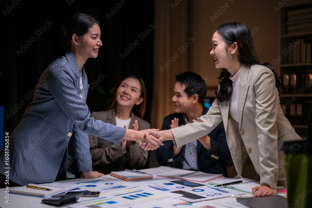 Fototapeta premium A woman shakes hands with another woman
