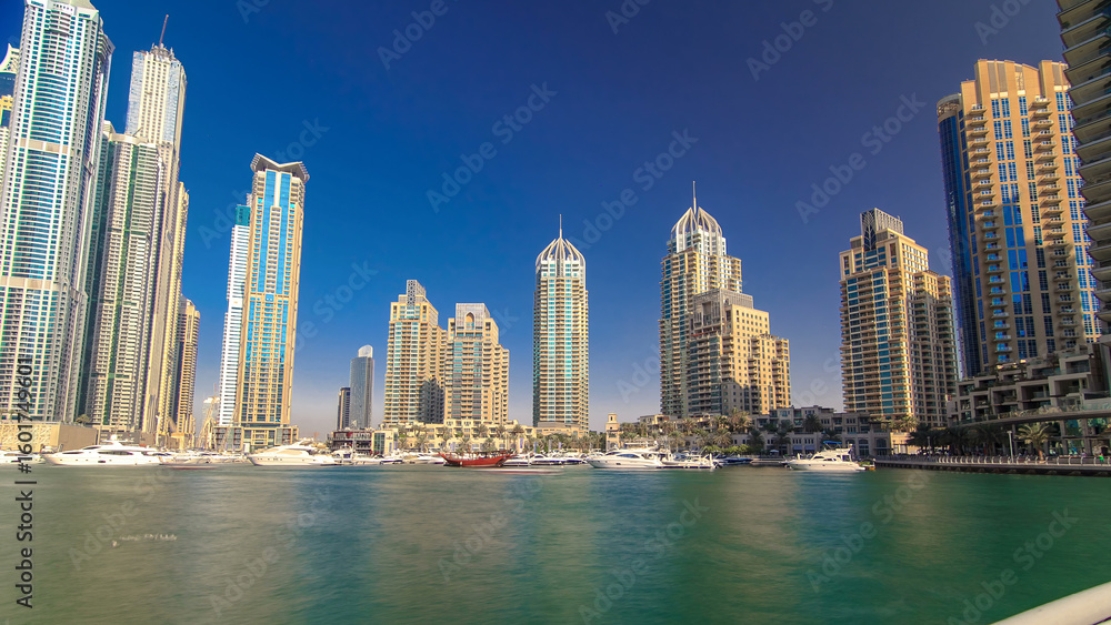 Fototapeta premium Dubai Marina with tallest skyscrapers and boats timelapse hyperlapse