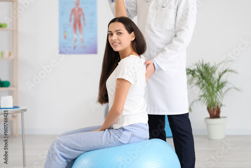 Male doctor checking postur...