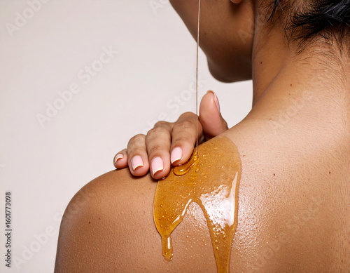 Woman applying oil on skin. Skin care editorial photoshoot. Cosmetics campaign.