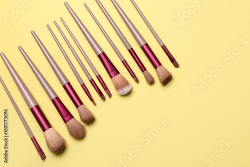 Makeup brushes on yellow ba...