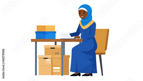 Smiling Black Muslim woman in a blue hijab and abaya working at a desk surrounded by boxes.