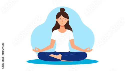Serene woman with a top knot bun meditating in a lotus pose, wearing a white shirt and blue pants.