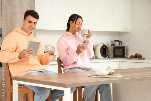 Young couple with cups of c...