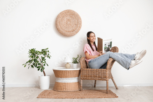 Young woman reading magazin...