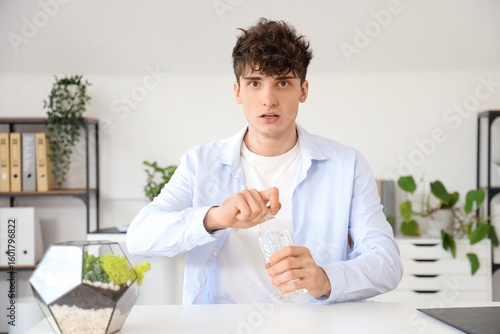 Young man with water bottle...
