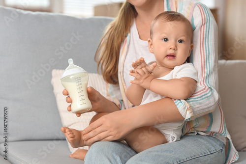 Mother holding baby with mi...
