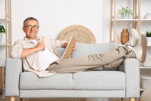 Old man lying on sofa and w...