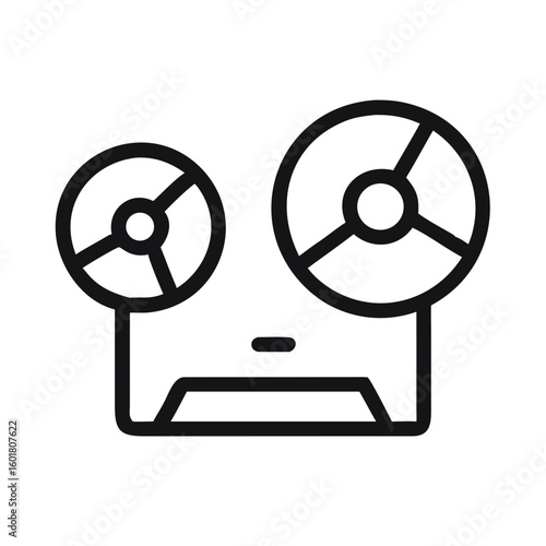 Silhouette of an Open Reel Tape Drive With Rotating Reels in a Dimly Lit Environment