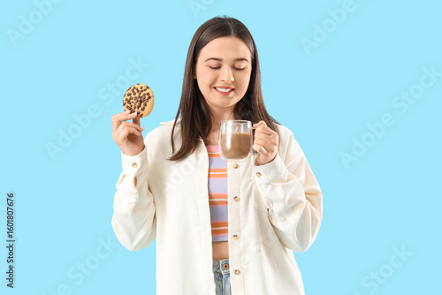 Young woman with cookie and...