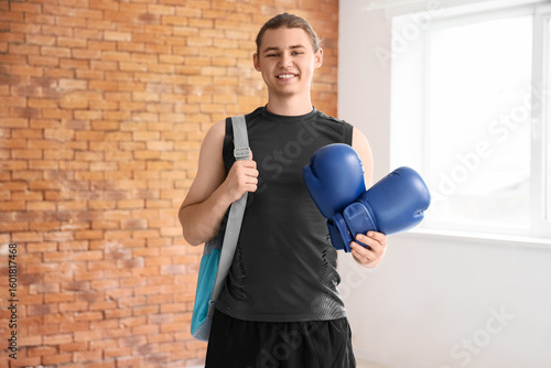 Sporty young man with boxin...