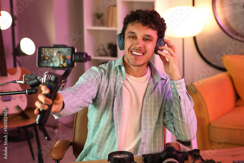 Male blogger in headphones ...