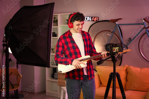 Male blogger with guitar re...