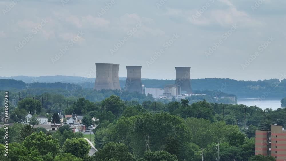 Nuclear cooling towers in suburb of American town. Aerial wide shot. Dangerous power plant producing energy. Panorama view. Nuclear cooling towers in suburb of American town. Aerial wide shot. Dangerous power plant producing energy. Panorama view.