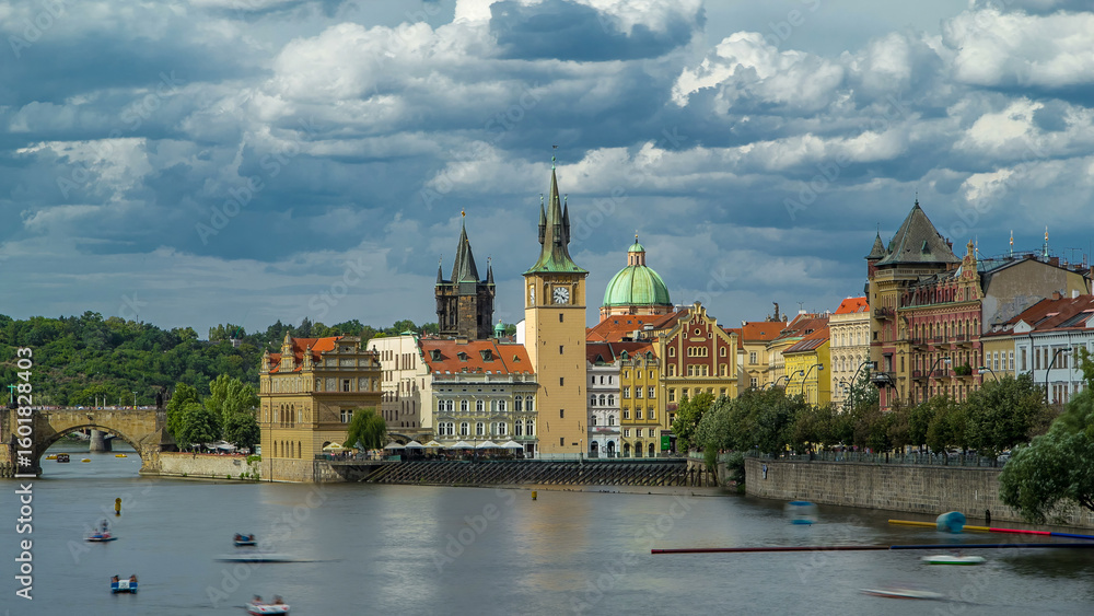 Fototapeta premium Charles Bridge and historical buildings timelapse in Prague from across the river. Prague, Czech Republic.