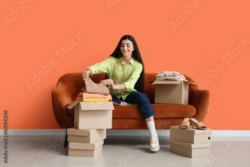 Young woman packing clothes...