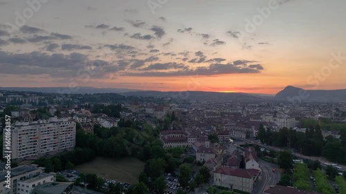 Aerial sunset view of Annecy in France with medieval castle colorful sky