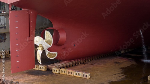 Tableau sur toile Propeller of large ship spinning power working and water splash contrail
