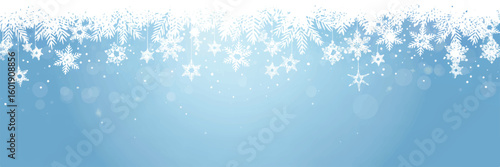 Winter christmas background with snowflakes and fir tree branches on a serene blue backdrop