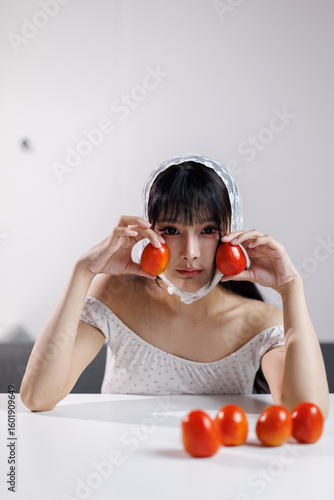 Beauty image of a young Health Asian girl show tomato with smiley face, health food concept, asian woman beauty a background of light and shadow 