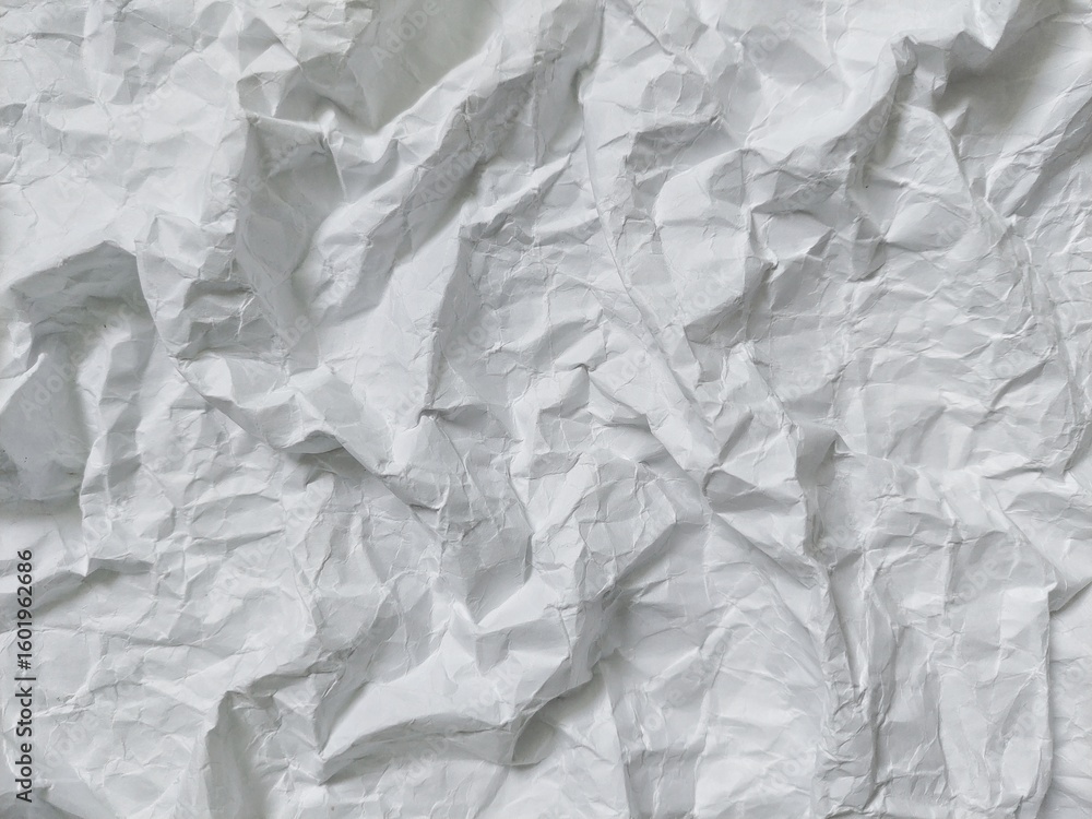 Fototapeta premium Crumpled white paper texture background with wavy surface. Crumpled white vintage paper surface texture for background. Wrinkled paper, abstract background. Paper background with copy space for text.
