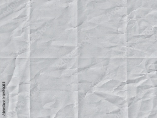 Crumpled white paper texture with fold lines. Crumpled blank white paper folded in four fraction background. Ideal for backgrounds, overlays, space for text, space for advertising copy.