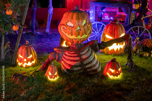 Big figure of angry pumpkin ay night. Halloween outdoor decor. Scary Jack o lantern