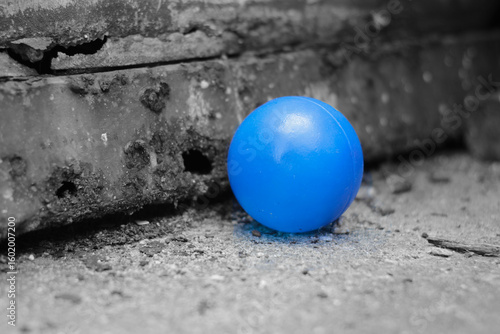 blue ball in a dramatic black and white setting
