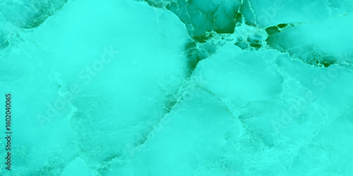 A stunning close-up of textured green marble, The surface features swirling veins and subtle cracks, with occasional soft green, creating a vibrant and refreshing visual effect.