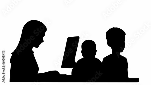 Silhouette of a woman at a computer with two children standing or sitting beside her in a black image