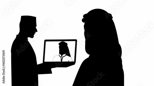 Silhouette of two people with one holding a laptop showing another person in traditional arab clothing