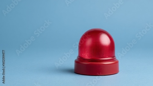 A solitary red alarm beacon hums in quiet anticipation, embodying emergency preparedness and the quirk of Alarm Day