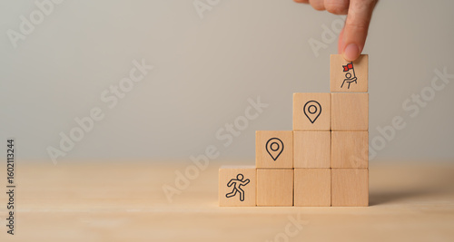 Career Path and Development Strategy Concept. Arranging wooden blocks with icons success roadmap and journey, symbolizing a structured career path and strategic development. Planning, growth, progress