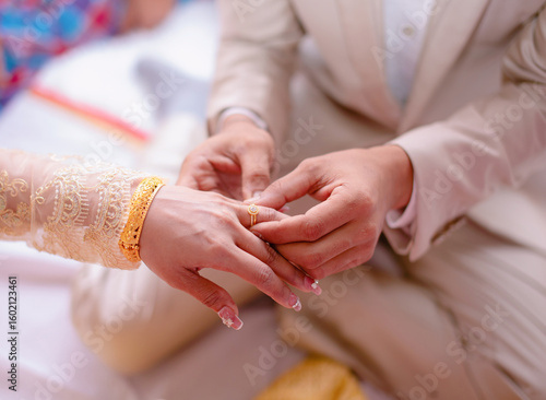 Man putting engagement ring on woman photo and close up of asian person