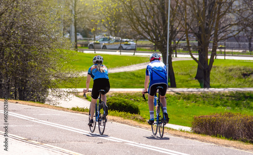 Wallpaper Mural Cyclists ride on the bike path in the city Park
 Torontodigital.ca