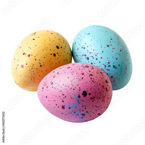 Three speckled eggs in pastel colors,  yellow, pink, and light blue,  grouped close together