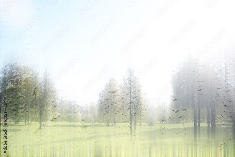 Fototapeta premium blurred background of an autumn landscape through a wet window