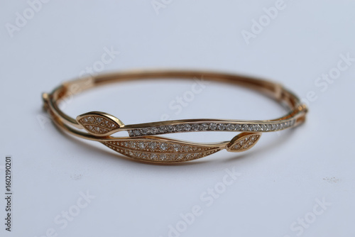 Gold bracelet with leaf design, studded with small stones
