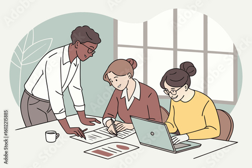 Team members collaborate on a project at a workspace during daytime while reviewing documents and discussing ideas over a laptop